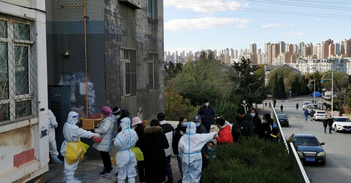 people line up for nucleic acid testing at a residential compound following local cases of the coronavirus disease covid 19 in dalian liaoning province china november 10 2021 china daily via reuters