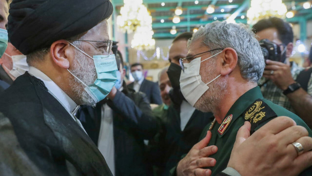 iran s president ebrahim raisi l greets the commander of the islamic revolutionary guard corps quds force brigadier general esmail qaani during a memorial event in march 2022   iranian presidency afp