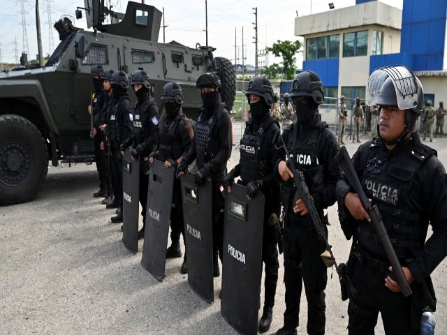 police officers stand guard as ecuador s former vice president jorge glas is expected to arrive at the la roca prison after ecuadorean forces raided mexico s embassy to arrest glas who had been convicted twice of corruption and who had been granted asylum by mexican authorities in guayaquil ecuador april 6 2024 reuters marcos