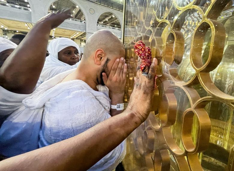 A Muslim pilgrim cries next to the Station of Ibrahim 