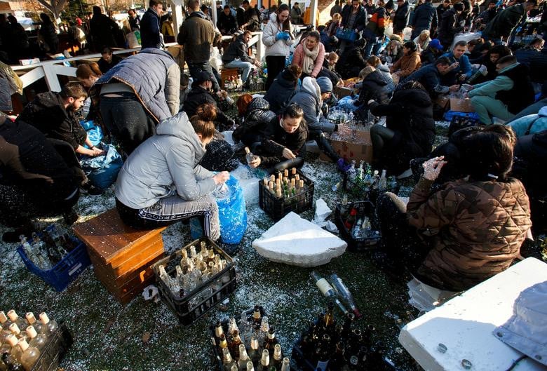Local residents prepare Molotov cocktails to defend the city, in Uzhhorod, Ukraine February 27. REUTERS