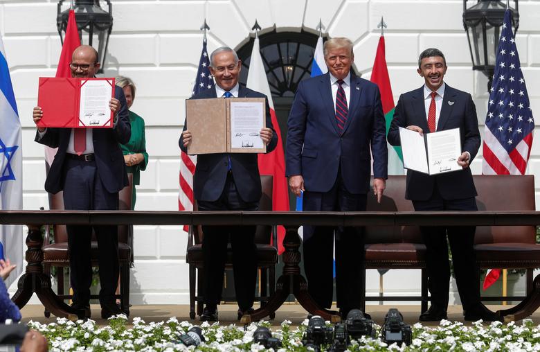 bahrain s foreign minister abdullatif al zayani israel s prime minister benjamin netanyahu and united arab emirates uae foreign minister abdullah bin zayed display their copies of signed agreements while u s president donald trump looks on as they participate in the signing ceremony of the abraham accords normalizing relations between israel and some of its middle east neighbors in a strategic realignment of middle eastern countries against iran on the south lawn of the white house september 15 reuters