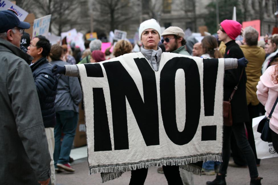 A woman displays a blanket at the Women's March. REUTERS/Canice Leung