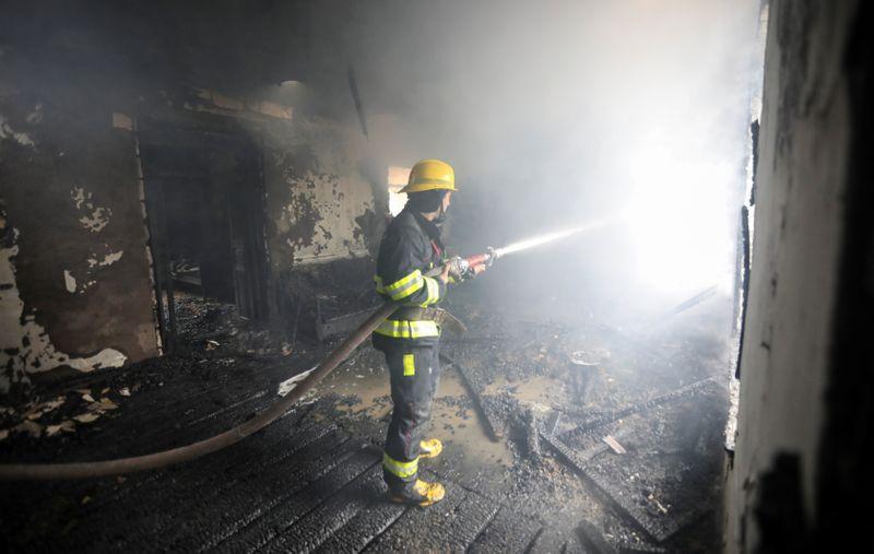 a firefighters extinguishes a fire in a house caused by shelling in the fighting over the breakaway region of nagorno karabakh in the town of barda azerbaijan october 5 2020 reuters