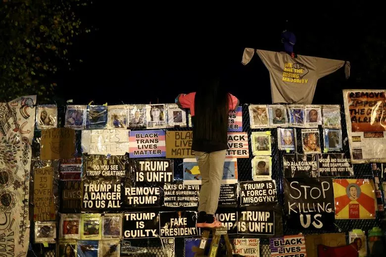 a supporter of joe biden looks over a fence to the white house reuters a supporter of joe biden looks over a fence to the white house reuters