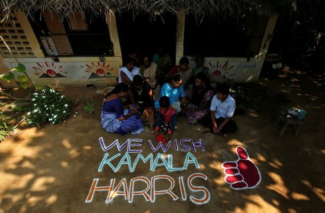 women and children sit next to a message for u s democratic vice presidential nominee kamala harris in painganadu near the village of thulasendrapuram where harris maternal grandfather was born and grew up in tamil nadu state india november 5 2020 reuters