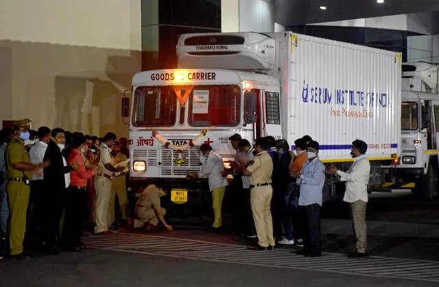 a police officer performs prayers in front of a truck carrying first consignment of covishield a coronavirus disease vaccine developed by astrazeneca and oxford university before it leaves from serum bio pharma park of serum institute of india for its distribution in pune india january 12 2021 reuters a police officer performs prayers in front of a truck carrying first consignment of covishield a coronavirus disease vaccine developed by astrazeneca and oxford university before it leaves from serum bio pharma park of serum institute of india for its distribution in pune india january 12 2021 reuters