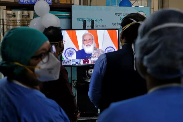 healthcare workers watch indian prime minister narendra modi addressing them through video conferencing to launch one of the world s largest covid 19 vaccination campaigns at a government run hospital in kolkata india january 16 2021 reuters healthcare workers watch indian prime minister narendra modi addressing them through video conferencing to launch one of the world s largest covid 19 vaccination campaigns at a government run hospital in kolkata india january 16 2021 reuters