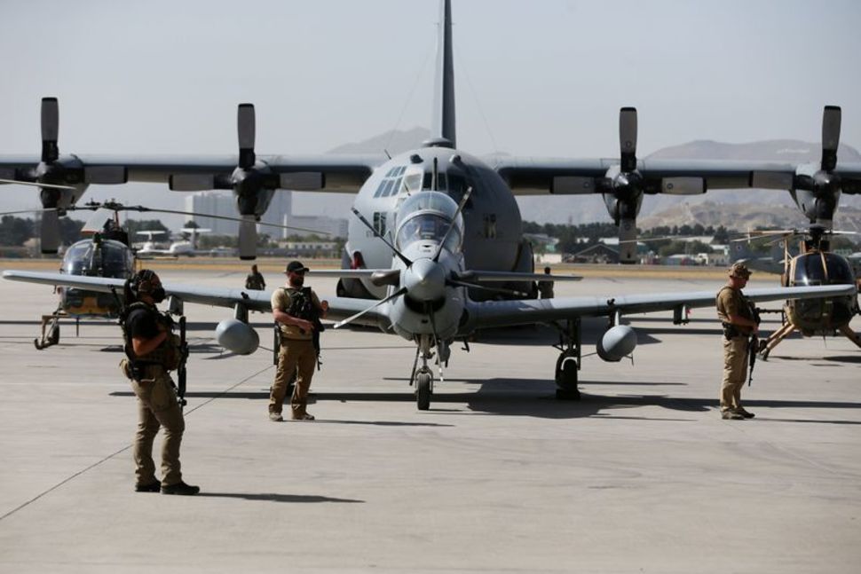 u s security personnel stand guard during a handover ceremony of a 29 super tucano planes from u s to the afghan forces in kabul afghanistan september 17 2020 reuters