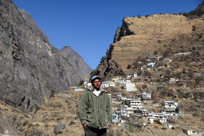 kundan singh 48 poses for a picture near his home after a flash flood swept down a mountain valley destroying dams and bridges in raini village in the northern state of uttarakhand india february 11 2021 picture taken february 11 2021 reuters