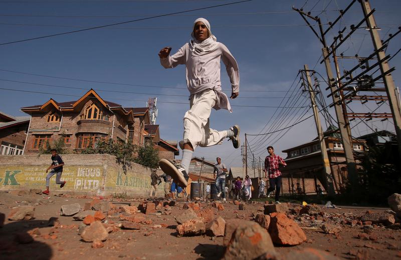 kashmiris run for cover as indian security forces not pictured fire teargas shells during clashes after scrapping of the special constitutional status for kashmir by the indian government in srinagar september 6 2019 reuters