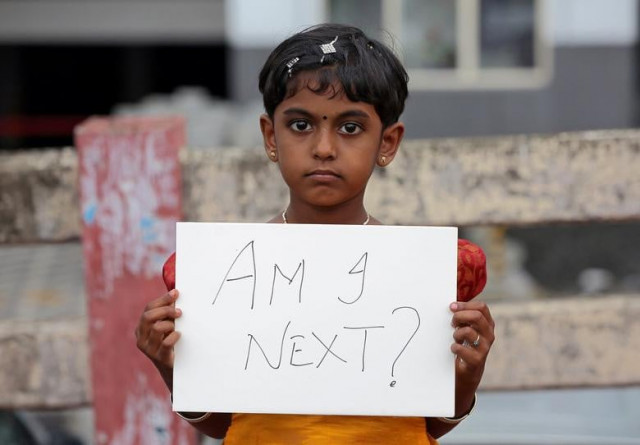 a gild holds a placard during a protest against the rape of an eight year old girl in kathua near jammu in kochi india april 15 2018 photo reuters file a gild holds a placard during a protest against the rape of an eight year old girl in kathua near jammu in kochi india april 15 2018 photo reuters file