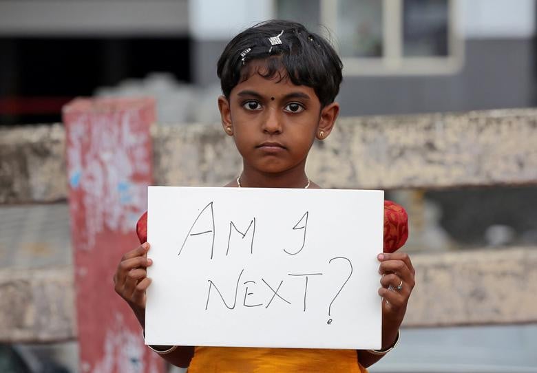 a gild holds a placard during a protest against the rape of an eight year old girl in kathua near jammu in kochi india april 15 2018 photo reuters file