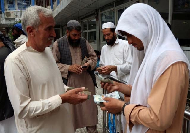 afghan money changers gather to deal with foreign currency at a money change market in herat province afghanistan photo reuters file afghan money changers gather to deal with foreign currency at a money change market in herat province afghanistan photo reuters file