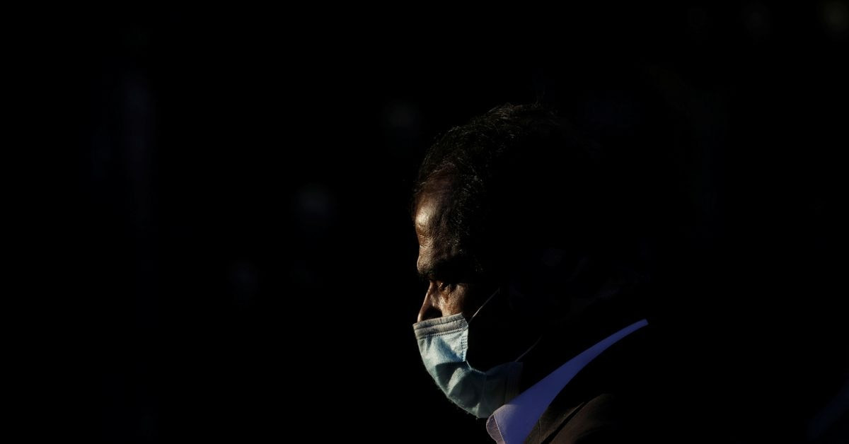a man wears protective mask to prevent the spread of the coronavirus disease covid 19 while he walks along a road in karachi pakistan january 12 2021 reuters