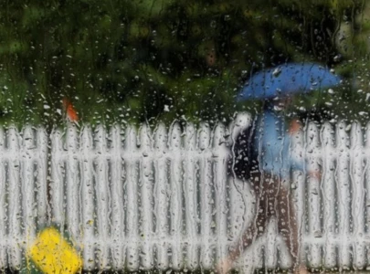 a pedestrian under an umbrella passes a rain covered car window photo reuters file a pedestrian under an umbrella passes a rain covered car window photo reuters file
