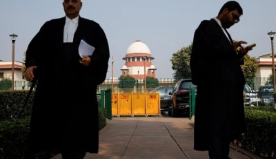 a lawyer looks into his mobile phone as another walks past in front of india s supreme court in new delhi december 11 2023 reuters adnan abidi