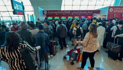 passengers queue at a flight connection desk at the dubai international airport dubai s major international airport diverted scores of incoming flights on april 16 as heavy rains lashed the united arab emirates causing widespread flooding around the desert country photo afp