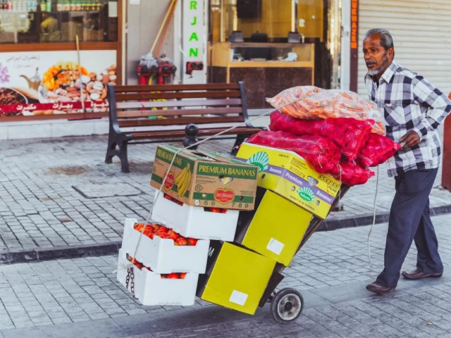 a worker pushing the cart in dubai photo pexels a worker pushing the cart in dubai photo pexels