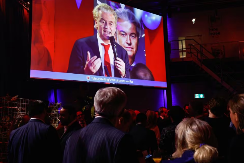 dutch far right politician and leader of the pvv party geert wilders appears on a screen as supporters of dilan yesilgoz the leader of vvd gather for exit poll and early results in the dutch parliamentary elections in the hague netherlands november 22 2023 reuters piroschka van de wouw acquire licensing rights