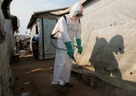 a health worker in full personal protective equipment ppe disinfects an area while preparing for the burial of suspected ebola victims at the kigonze displaced persons camp in bunia eastern democratic republic of congo on june 18 2026 one month after the outbreak was declared reuters