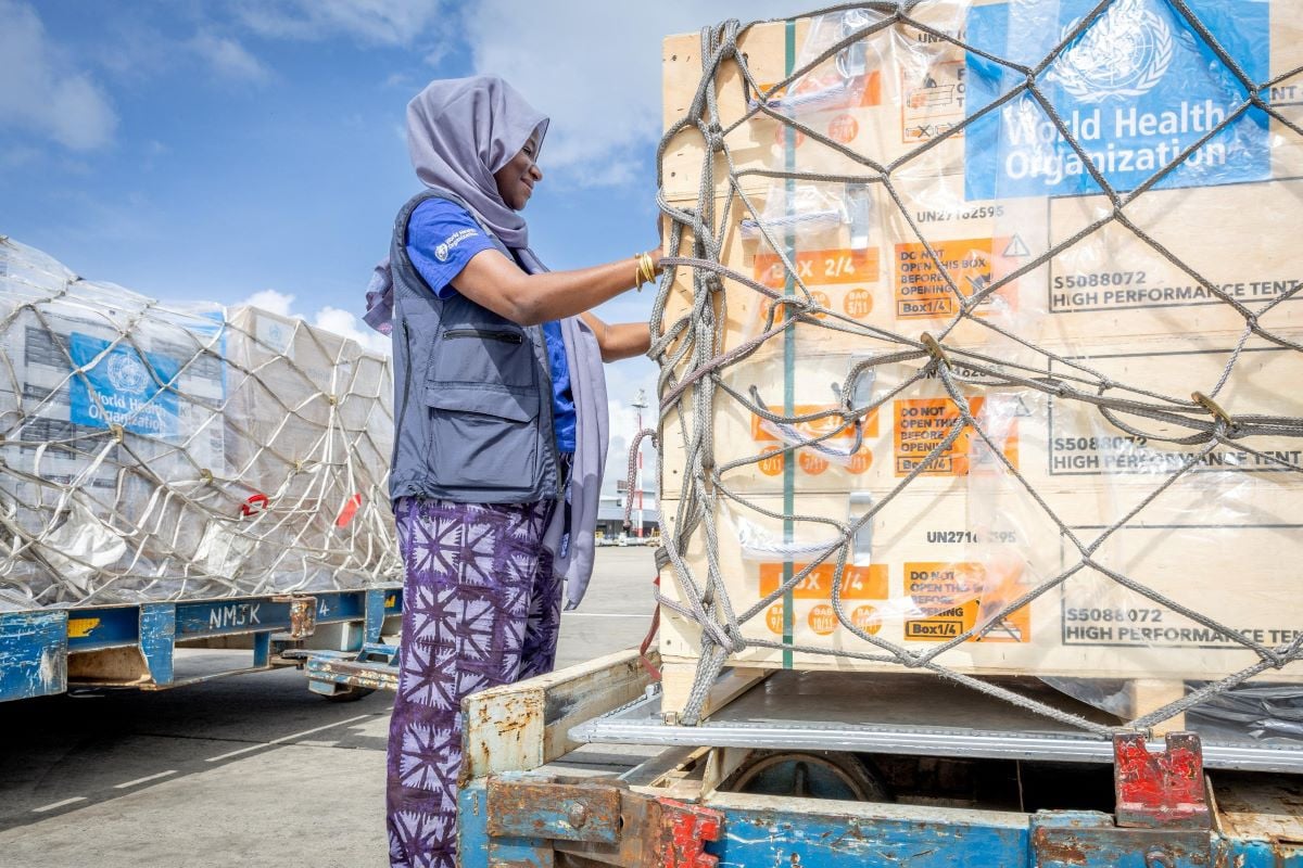 Fatima Tafida, the Regional Supply Chain Lead for Emergencies at the World Health Organization's (WHO) Regional Office for Africa pastes stickers on shipment pallets as the WHO mobilises 4.7 tonnes of essential medical supplies and emergency kits to support the affected regions in response to the Ebola outbreak in the Democratic Republic of Congo from the Jomo Kenyatta International Airport (JKIA) in Nairobi, Kenya May 18, 2026.  World Health Organization, REUTERS