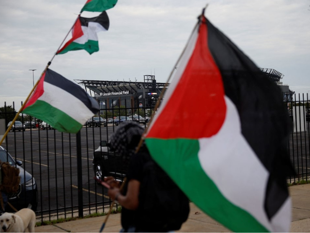 Pro-Palestinian protesters demonstrate near the venue of pop star Ed Sheeran's concert after rapper Macklemore was cut from the musical lineup over his 