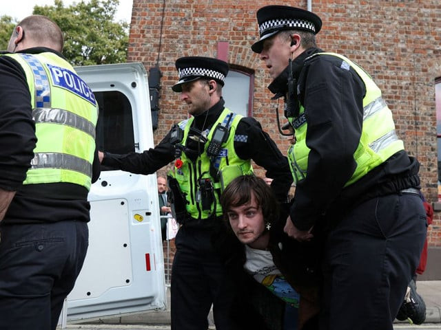police officers remove a man arrested for throwing eggs at king charles during his visit to micklegate bar in york britain november 9 2022 photo reuters police officers remove a man arrested for throwing eggs at king charles during his visit to micklegate bar in york britain november 9 2022 photo reuters