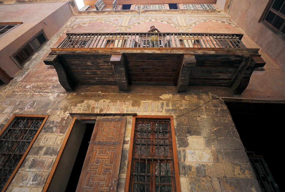  A young woman stands in front of an old wooden door by a historic house in Darb al-Ahmar neighbourhood in Cairo, Egypt August 31, 2019. PHOTO: REUTERS