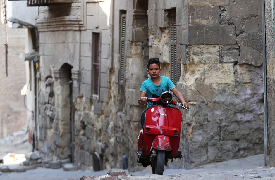  A young woman stands in front of an old wooden door by a historic house in Darb al-Ahmar neighbourhood in Cairo, Egypt August 31, 2019. PHOTO: REUTERS