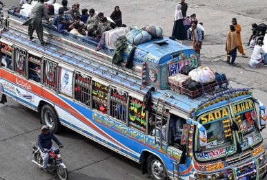 passengers ride an overcrowded bus while returning to their hometowns ahead of eidul fitr which marks the end of the islamic holy fasting month of ramazan in lahore on march 19 2026 photo afp