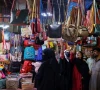 people look at handbags on display outside shops in a market ahead of eidul fitr celebrations in karachi photo reuters