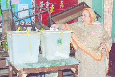 electoral moment a woman casts her vote in by election in faisalabad photo online