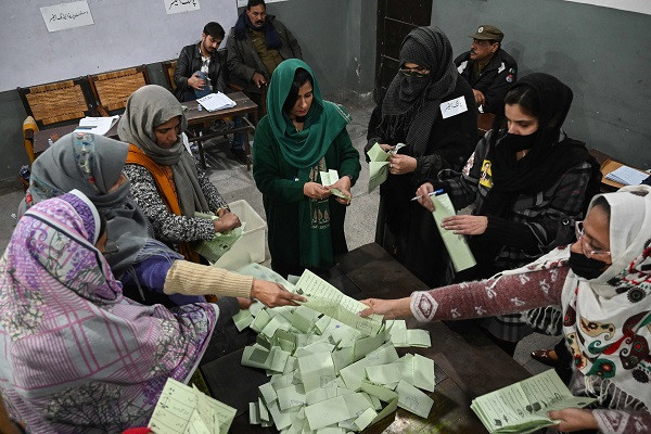 election officials count ballot papers after polls close at a polling station in lahore on february 8 2024 photo afp