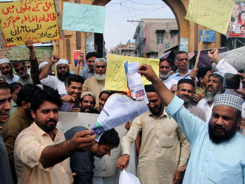 people burn electricity bills as they hold protest demonstration against inflated electricity bills in peshawar s gunj chowk on august 26 2023 photo ppi