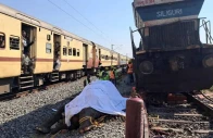 train passengers use their mobile phones to take photographs of a dead elephant after it was hit by a train in hojai district in the eastern state of assam india december 20 2025 reuters