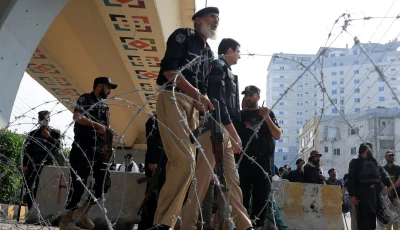 police guard a road leading to red zone in peshawar on october 11 2026 photo reuters