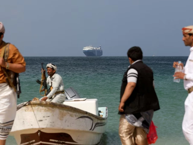 armed men stand on the beach as the galaxy leader commercial ship seized by yemen s houthis last month is anchored off the coast of al salif yemen december 5 2023 reuters khaled abdullah file photo armed men stand on the beach as the galaxy leader commercial ship seized by yemen s houthis last month is anchored off the coast of al salif yemen december 5 2023 reuters khaled abdullah file photo