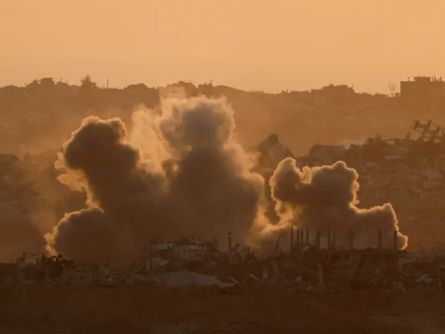 Explosions send smoke into the air in Gaza on Thursday evening [Amir Cohen/Reuters]