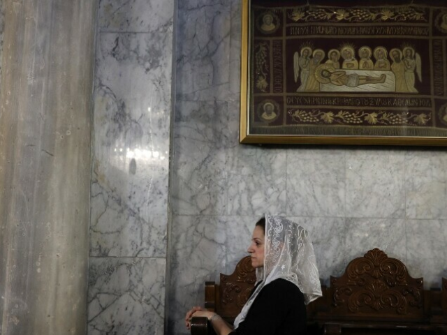 A Christian Palestinian woman attends the funeral ceremony of Saad Salameh and Foumia Ayyad, killed earlier in an Israeli strike that hit the Holy Family Church in Gaza City, at the Saint Porphyrius Church on July 17. — AFP