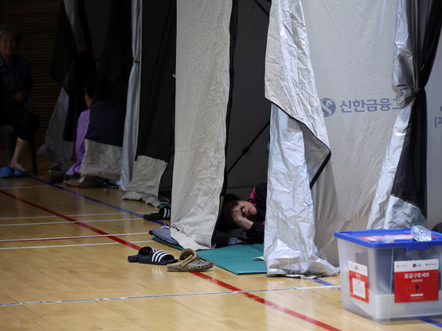 People evacuated from villages, damaged by torrential rain, rest at a temporary shelter, in Yesan, South Korea, July 18, 2025. REUTERS/Kim Hong-Ji