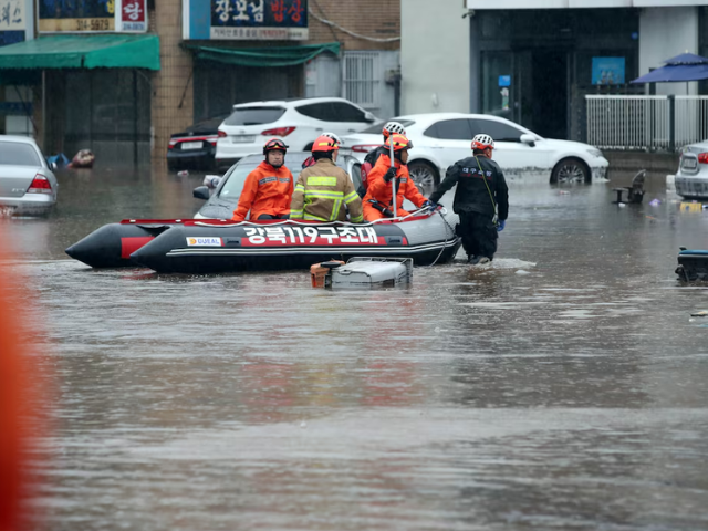 Firefighters take part in a rescue operation at a flooded area caused by torrential rain in Daegu, South Korea, July 17, 2025. Yonhap via REUTERS/File Photo