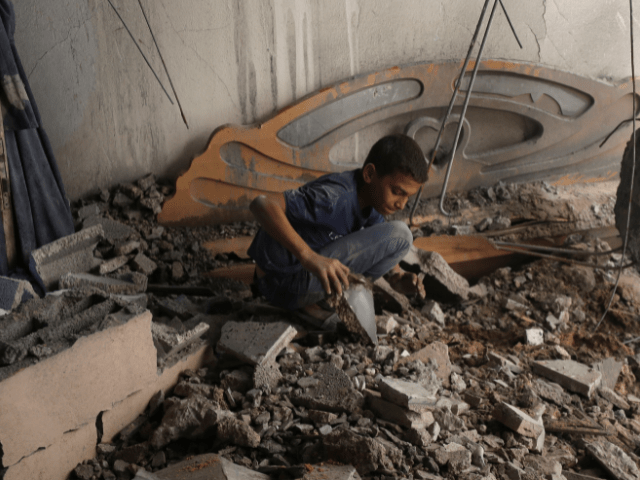 A Palestinian boy inspects the site of an overnight Israeli air strike on a house in Gaza City on July 23, 2025. — Reuters