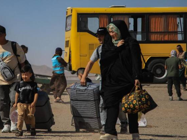 An Iranian bus drops off Afghan refugees at Zero Point on the Islam Qala border in Herat Province on July 24, 2025. (AFP)