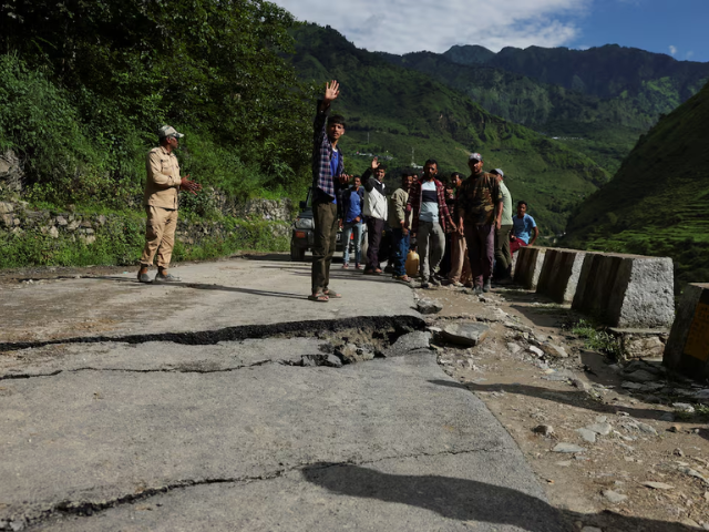 A drone view of an excavator, as it clears debris from a damaged road after a landslide in Bhatwadi village at Uttarkashi district of Uttarakhand, India, August 7, 2025. REUTERS
