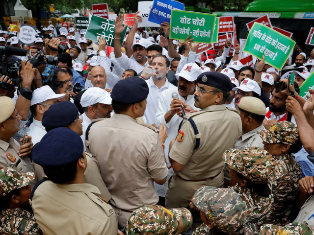 Rahul Gandhi, a lawmaker and a leader of India's main opposition Congress party, drinks water as he is stopped by police along with other lawmakers during a protest against what they say are electoral malpractices, in New Delhi, India, August 11, 2025. REUTERS