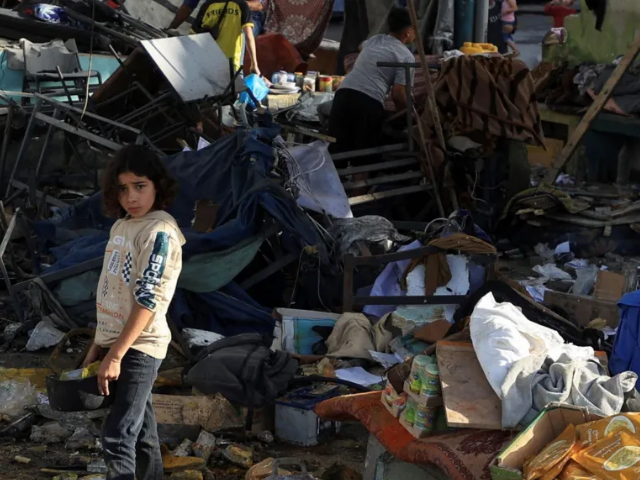 A girl stands in the ruins of the school building in Gaza City that was hit by an air strike Photo: Reuters