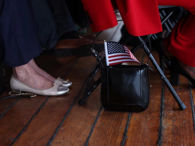 a u s flag sticks out from the purse of a citizen candidate attending a u s citizenship and immigration services uscis naturalization ceremony aboard the 1885 tall ship wavertree at the south street seaport in new york city u s june 14 2023 reuters a u s flag sticks out from the purse of a citizen candidate attending a u s citizenship and immigration services uscis naturalization ceremony aboard the 1885 tall ship wavertree at the south street seaport in new york city u s june 14 2023 reuters