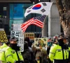 a group of far right protesters gather to support former south korean president yoon suk yeol before a bus carrying him arrives for a first court ruling in a case including obstruction of arrest linked to his martial law declaration at a court in seoul south korea january 16 2026 reuters