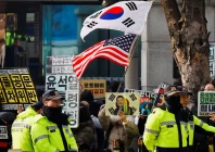 a group of far right protesters gather to support former south korean president yoon suk yeol before a bus carrying him arrives for a first court ruling in a case including obstruction of arrest linked to his martial law declaration at a court in seoul south korea january 16 2026 reuters